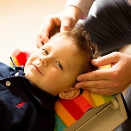 child having neck adjusted