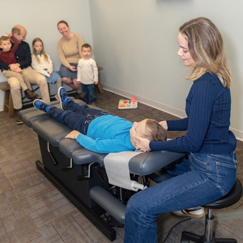 Chiropractor treating child with ear infection