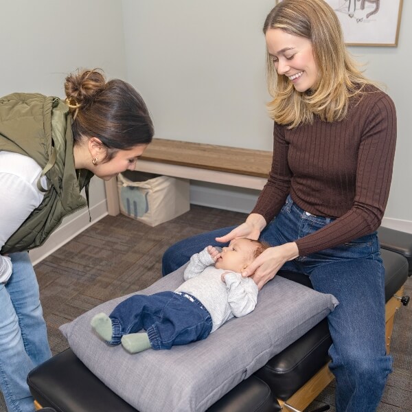 Chiropractor adjusting a baby
