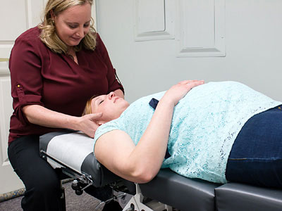 Dr Kate adjusting pregnant woman