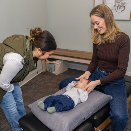 Dr Mackenzie adjusting baby