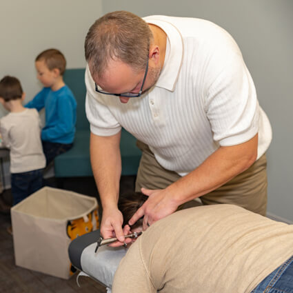 Dr. Pat using activator on patient