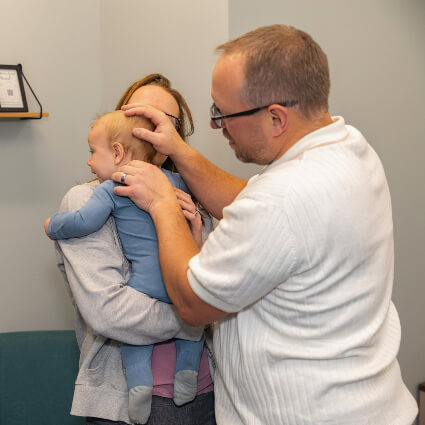 Dr. Pat adjusting baby