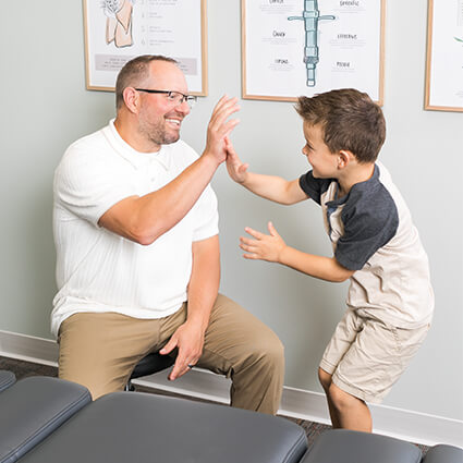 Brookfield chiro Dr Patrick high fiving child