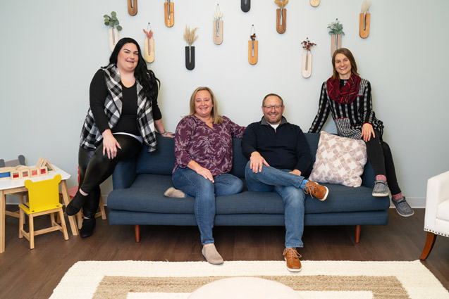 mccann chiropractic team sitting on blue couch
