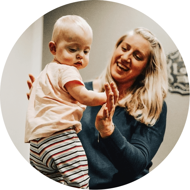 Dr. Mandy smiling with baby patient