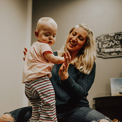 Dr Mandy smiling at a baby patient