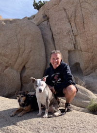 Dr. Paige hiking in Joshua Tree National Park with her dogs Roxy and Copa