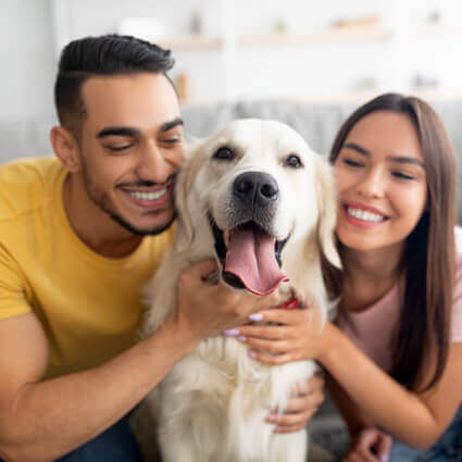 man-and-woman-smiling-with-dog-sq