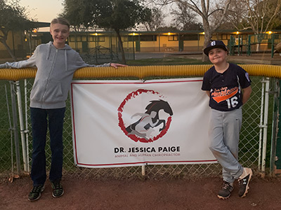 softball team members standing in front of our banner