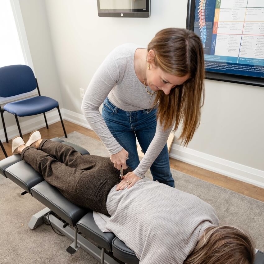 Dr Kate using tool on patients back