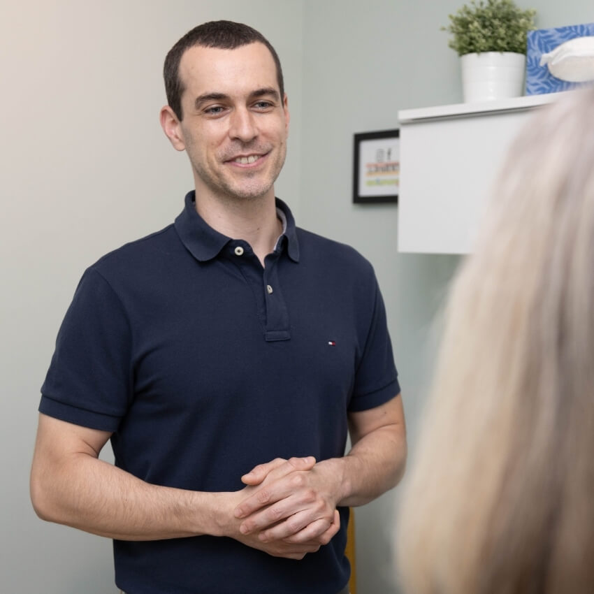 Mark talking with a patient