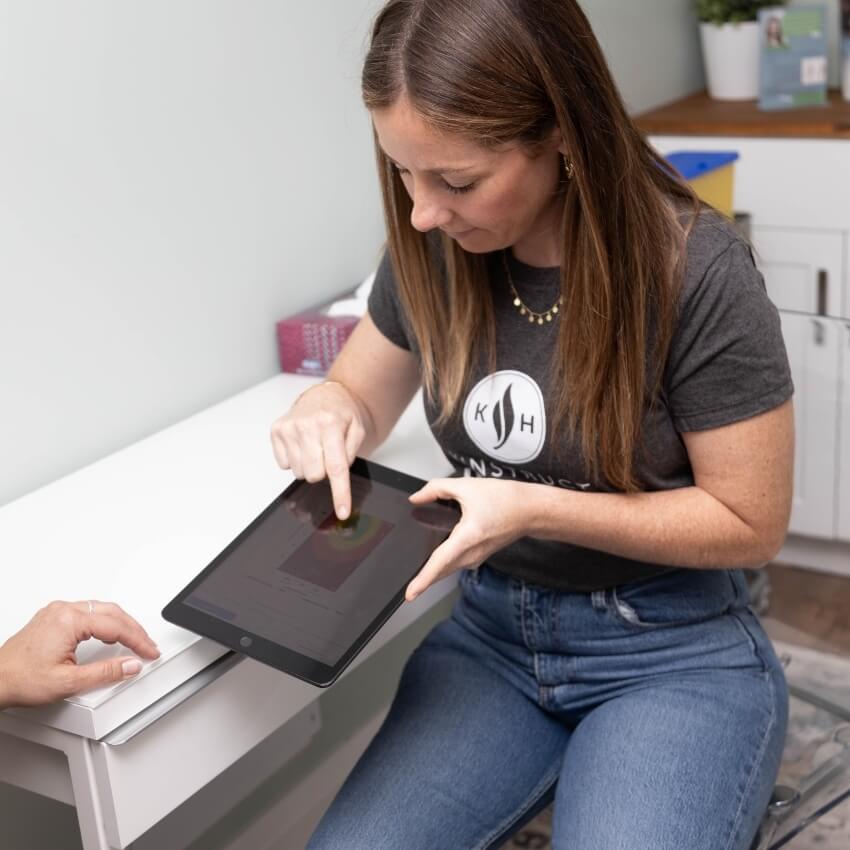 staff pointing at tablet