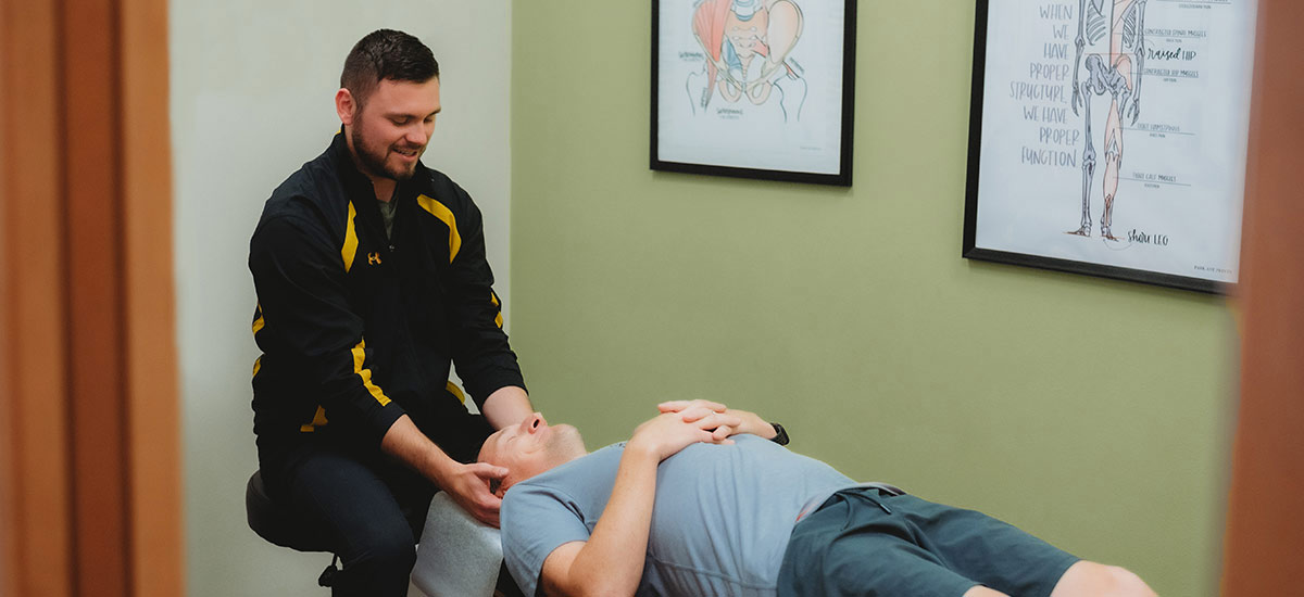 Dr Greg adjusting patients neck