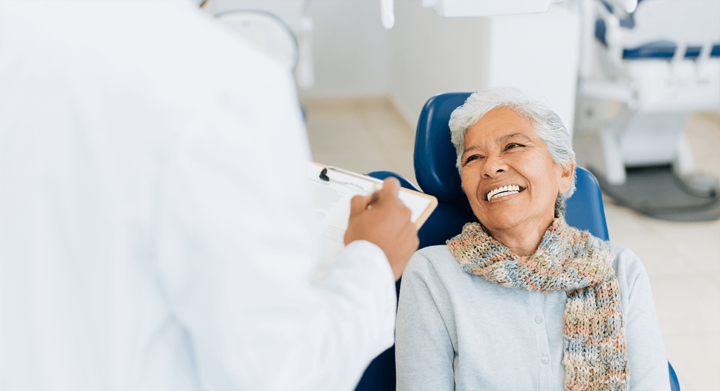 old woman talking to dentist