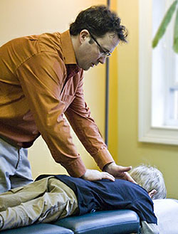 Dr. Port adjusting a child. East Cobb Chiropractor