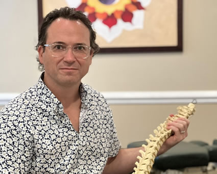 Dr. Wade holding spine model
