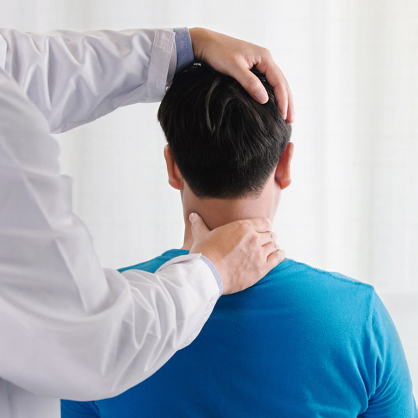 A man having his neck adjusted by a chiropractor