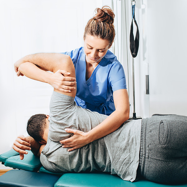 A chiropractor adjusting a patient's back