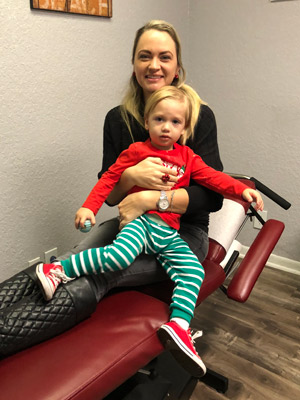 A chiropractic kid patient with her doctor