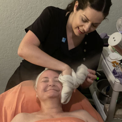 Applying facial cream to patient