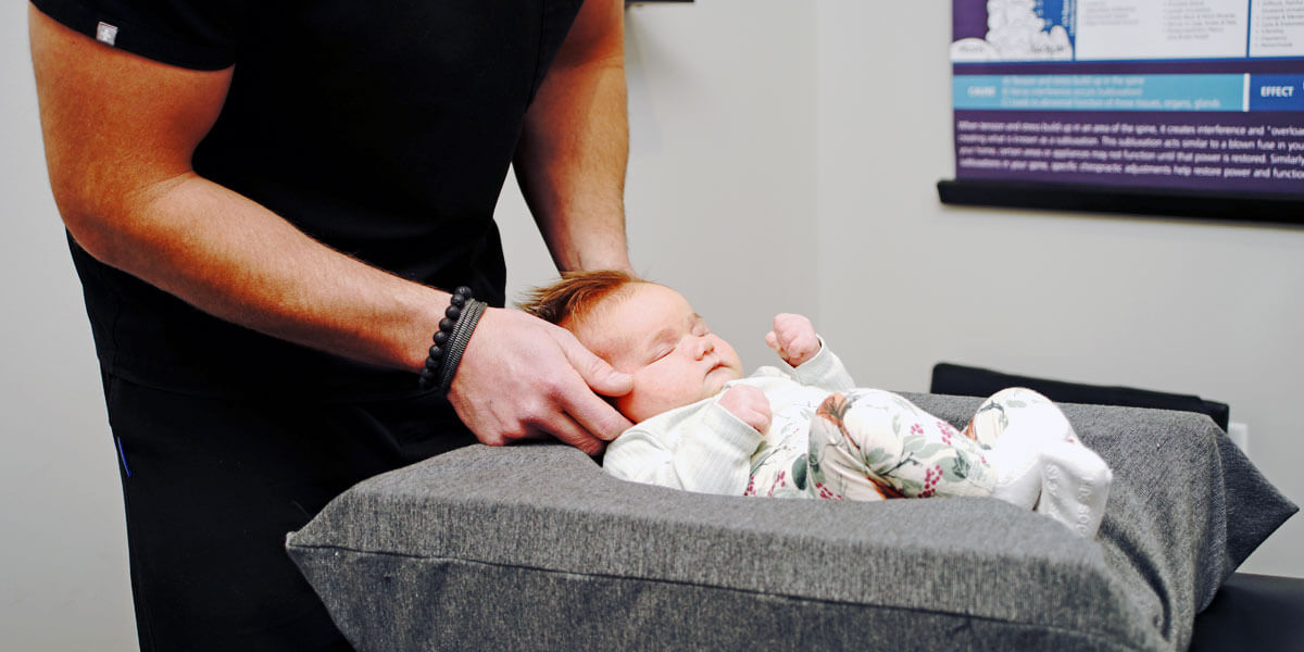 Newborn being adjusted