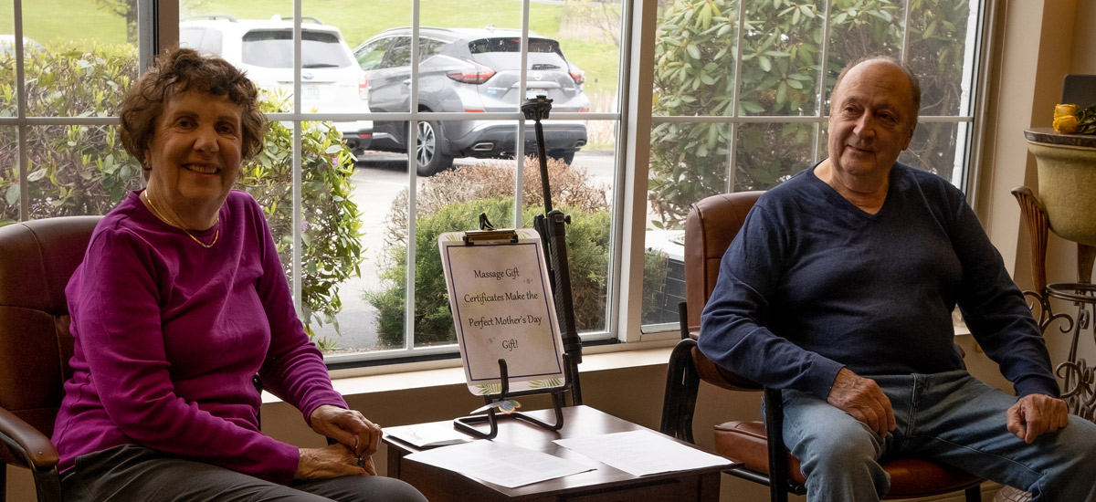 Happy couple sitting in comfortable waiting room