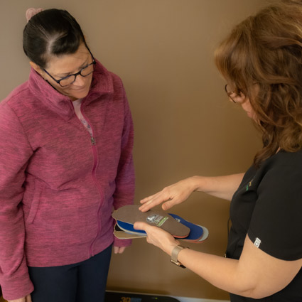 Patient looking at potential orthotic inserts