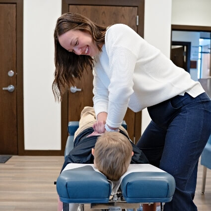 Megan adjusting kids upper back