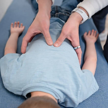 kid having lower back examined