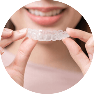 Woman holding clear orthodontic inserts