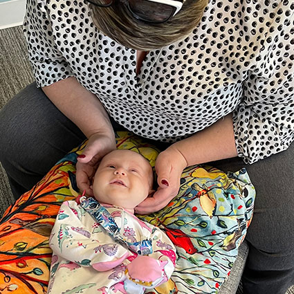 Dr Moore adjusting a baby patient