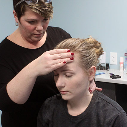 Dr Sandra adjusting a patient's neck