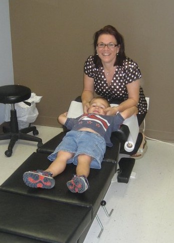 Photo of Dr. Sarah and a patient on a chiropractic table