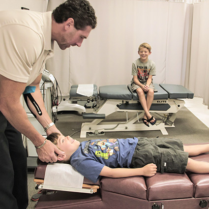 Doctor adjusting child