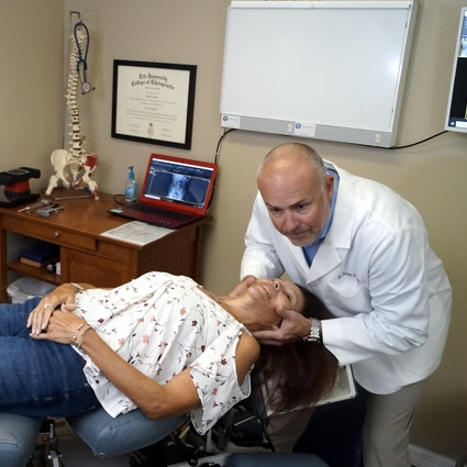 Dr Coletti adjusting womans neck