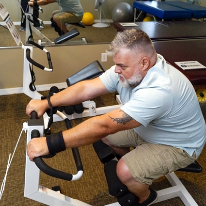 Man on equipment doing physiotherapy