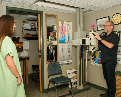 Chiropractor assisting patient with x-rays