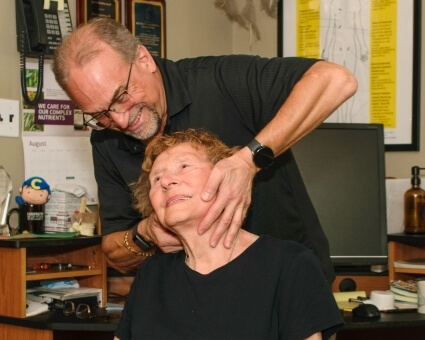 Chiropractic Care Chiropractor adjusting patient's neck
