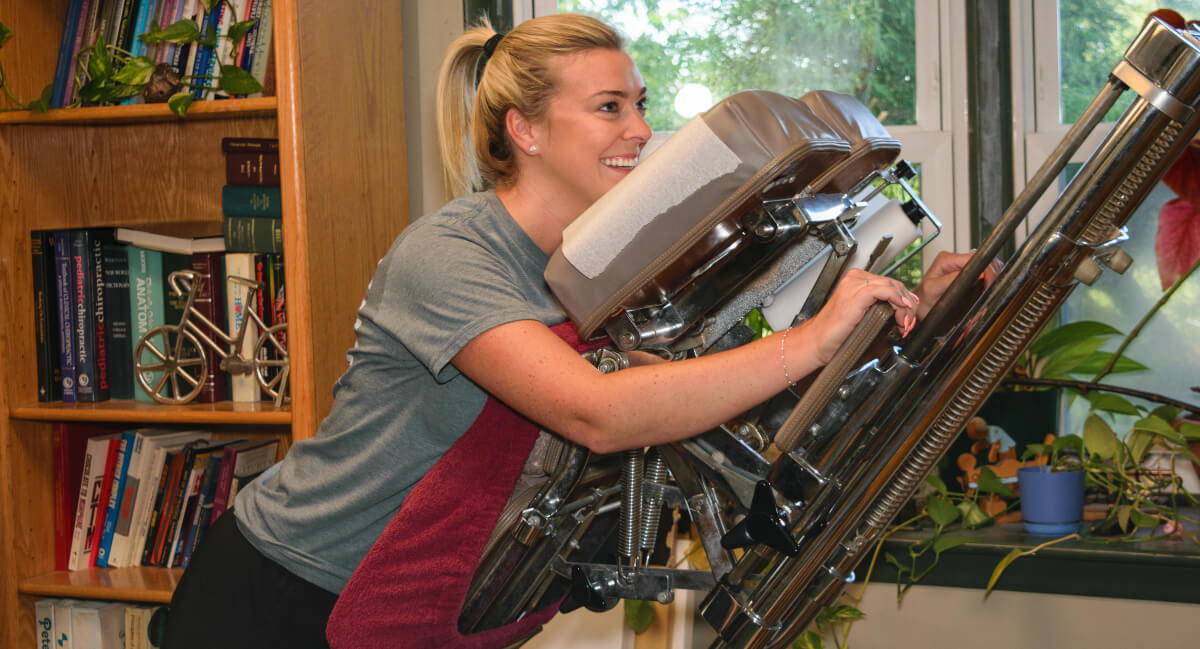 Smiling woman on chiropractic table