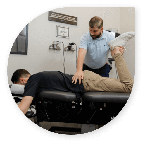 Bryant chiropractor adjusting patient's leg at Bryant Family Chiropractic