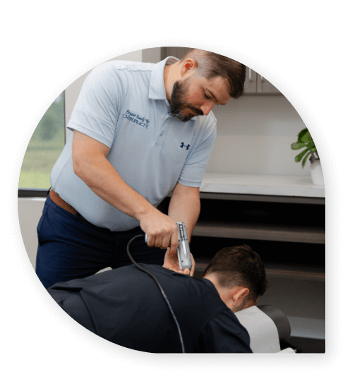 Bryant chiropractor using tool on patient