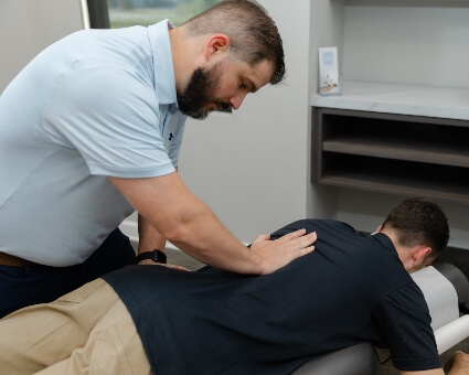 Bryant chiropractor adjusting patient