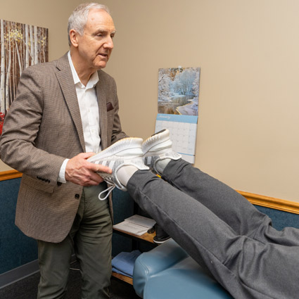 Dr. Bennett checking a patient's leg alignment