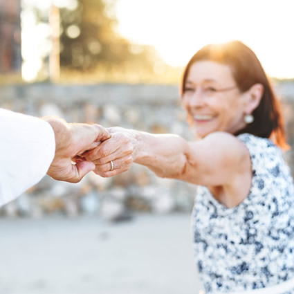 mature couple pulling hands