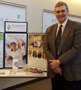 Partner with Schmidt Chiropractic Clinic Dr. Thomas Schmidt standing by table