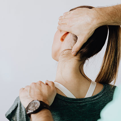 chiropractor adjusting patients neck