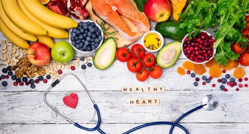 Variety of fruits and nuts, stethoscope, and heart health graphic