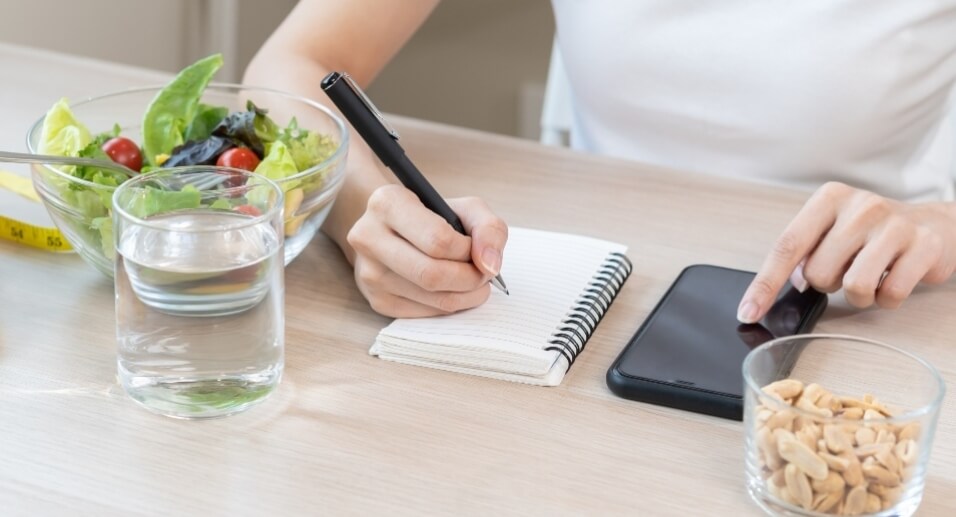 Woman writing on notepad