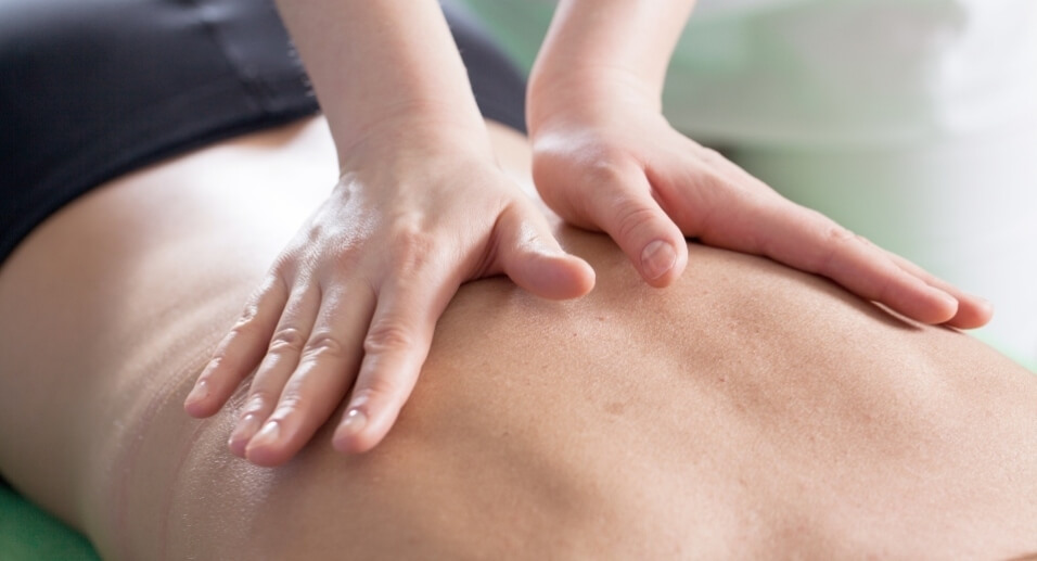 Male patient receiving a back adjustment